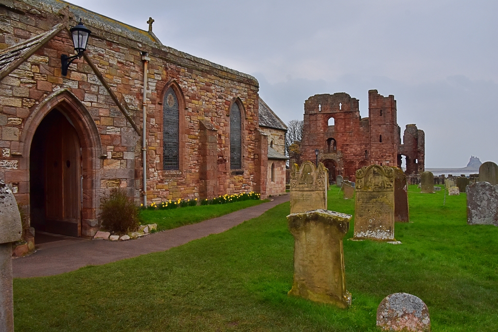 St Mary's Church with Lindisfarne Priory and Castle in the background © essentially-england.com