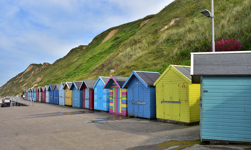 The Colourful Beach Huts Along East Cliff © essentially-england.com